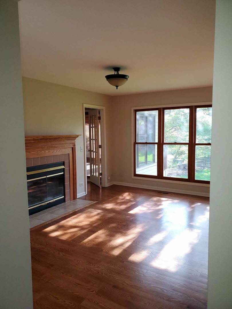 950 Ripple Brook Lane Elgin, IL 60120 - Photo 13 of 38 a view of an empty room with wooden floor fireplace and a window