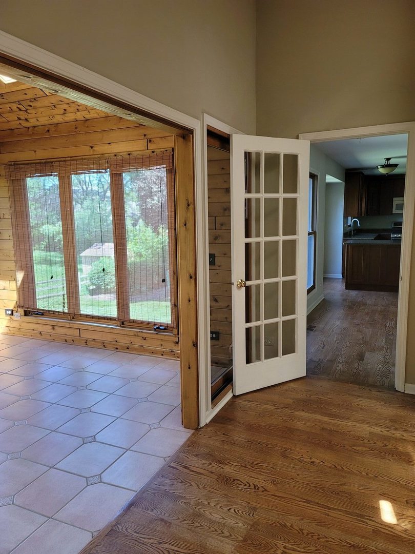 950 Ripple Brook Lane Elgin, IL 60120 - Photo 17 of 38 a view of an empty room with a window and wooden floor