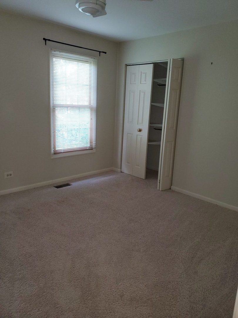 950 Ripple Brook Lane Elgin, IL 60120 - Photo 24 of 38 an empty room with closet and a window
