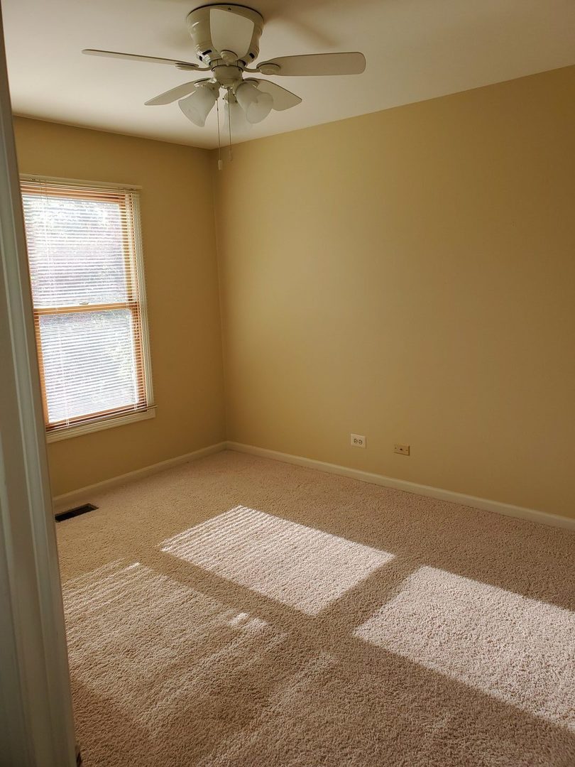 950 Ripple Brook Lane Elgin, IL 60120 - Photo 26 of 38 an empty room with windows and fan