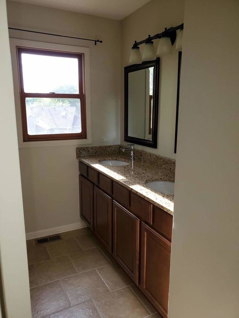 950 Ripple Brook Lane Elgin, IL 60120 - Photo 27 of 38 a bathroom with a granite countertop sink and mirror