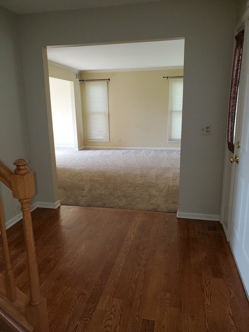 950 Ripple Brook Lane Elgin, IL 60120 - Photo 6 of 38 an empty room with wooden floor and windows