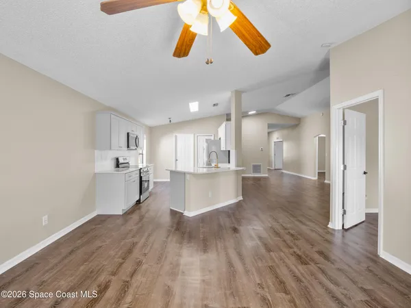 a view of kitchen and hall with wooden floor