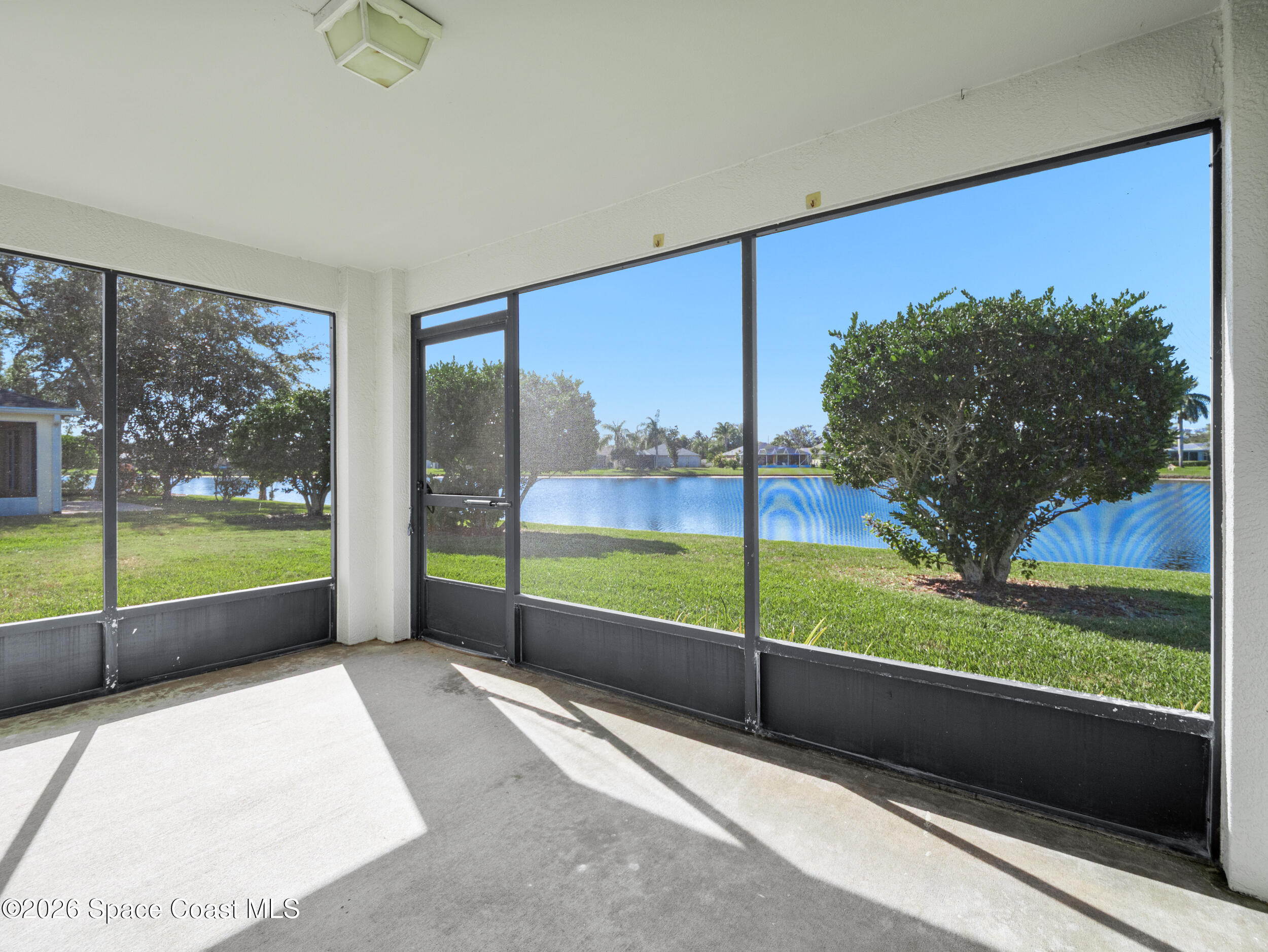 1273 Brumpton Place Rockledge, FL 32955 - Photo 35 of 39 Screened porch with lake views