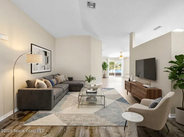 a living room with furniture and a flat screen tv