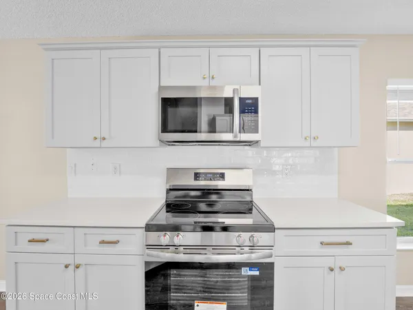 a stove top oven sitting inside of a kitchen