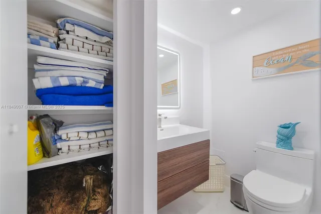 a bathroom with a toilet a sink and a mirror