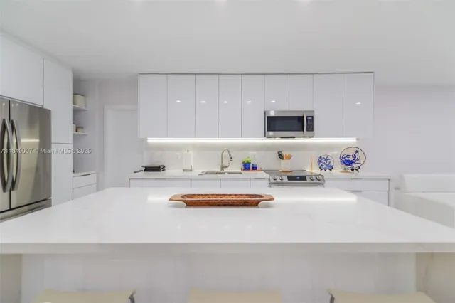 a kitchen with a sink stove and refrigerator
