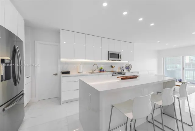 a kitchen with a sink cabinets and refrigerator