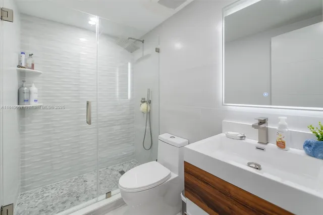 a bathroom with a sink toilet and shower