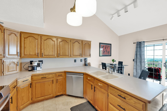 5057 South Ridgedale Drive Ogden, UT 84403 - Photo 29 of 69 Kitchen featuring wood cabinetry, a double basin sink, and ample countertop space