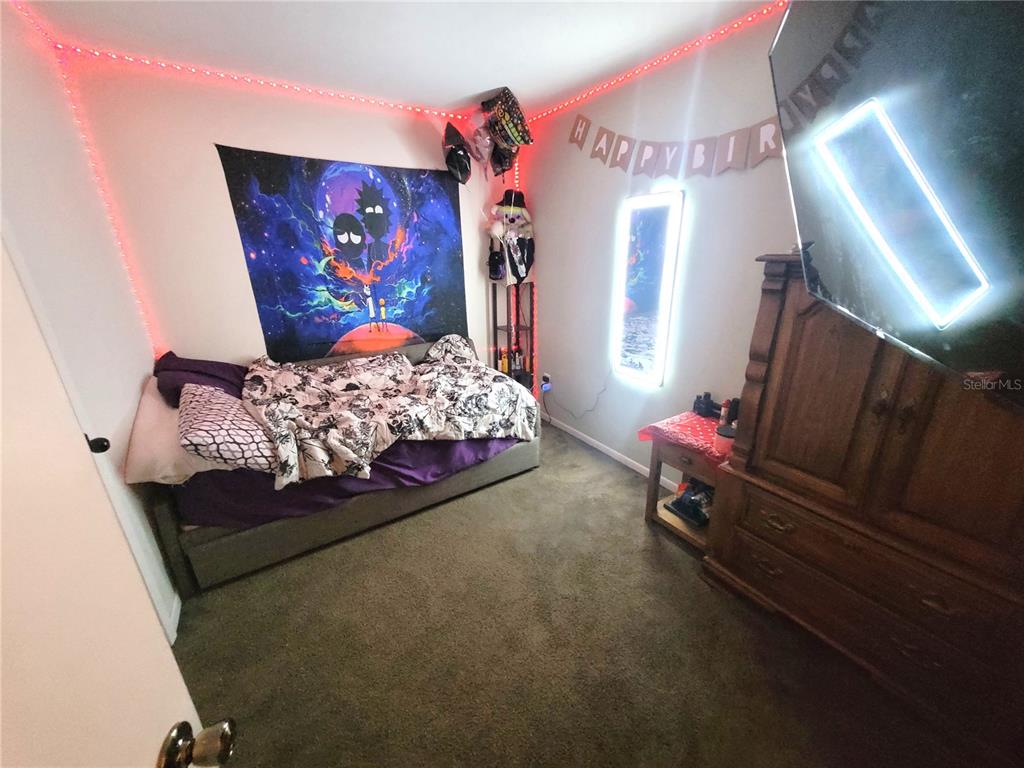 5203 Presidential Street Seffner, FL 33584 - Photo 12 of 21 a bedroom with bed and a lamp
