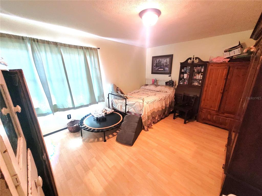 5203 Presidential Street Seffner, FL 33584 - Photo 13 of 21 a bedroom with furniture and a large window