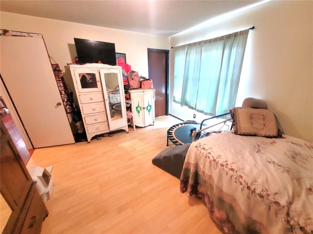 5203 Presidential Street Seffner, FL 33584 - Photo 14 of 21 a bedroom with a bed tv and a window