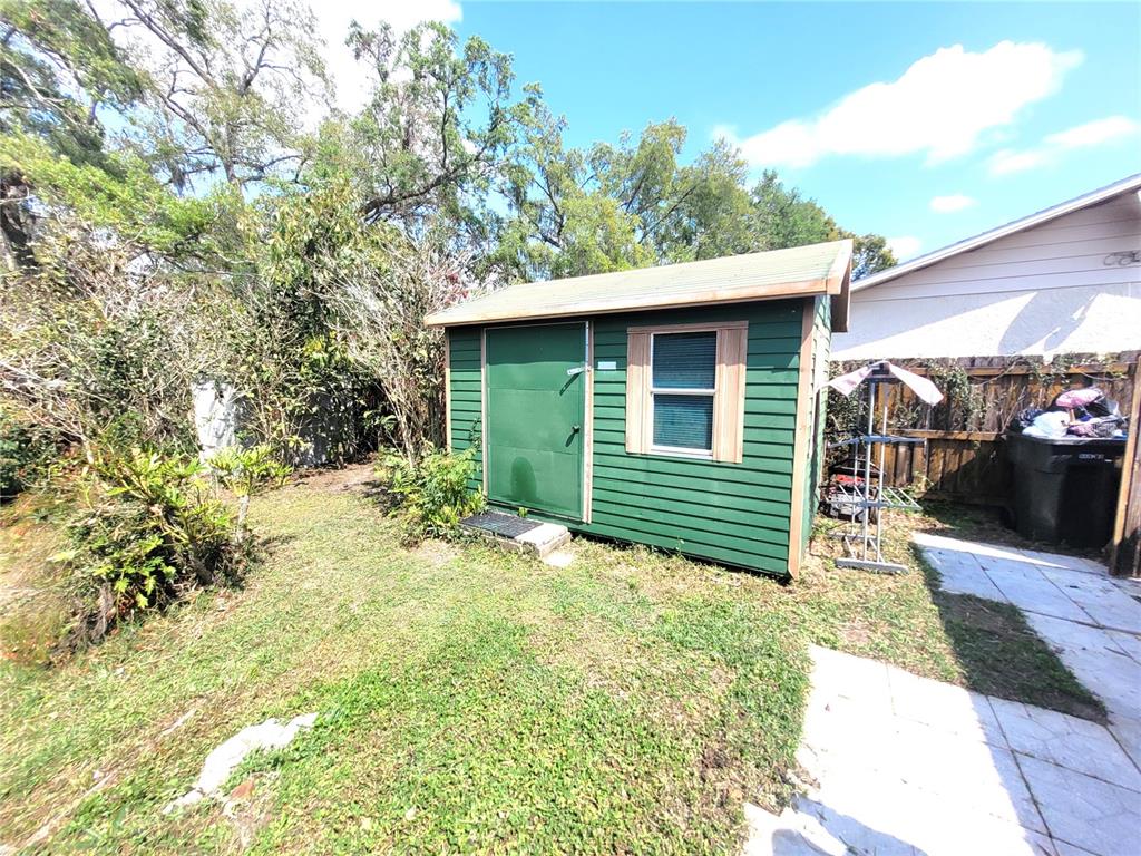 5203 Presidential Street Seffner, FL 33584 - Photo 18 of 21 a backyard of a house with table and chairs