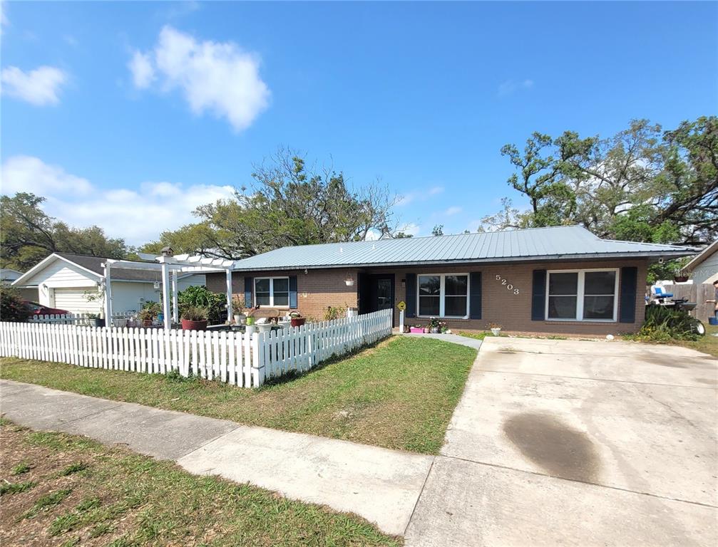 5203 Presidential Street Seffner, FL 33584 - Photo 3 of 21 front view of a house with a yard