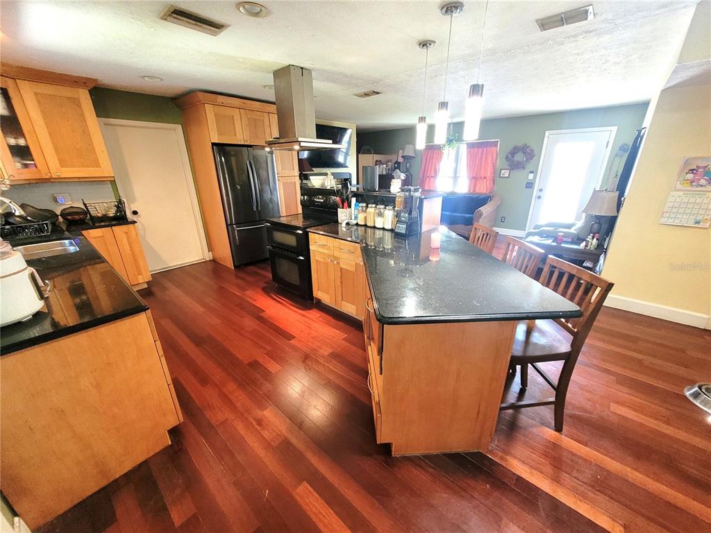 5203 Presidential Street Seffner, FL 33584 - Photo 7 of 21 a living room with wooden floor pool table and chairs