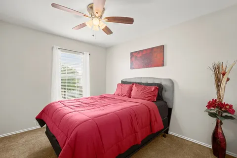a spacious bathroom with a granite countertop sink and a mirror