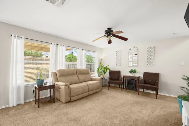 a view of living room filled with furniture and wooden floor