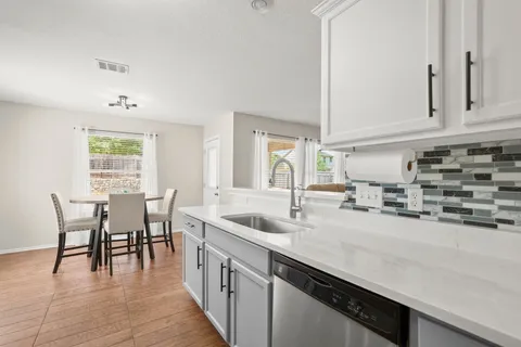 a kitchen with cabinets stainless steel appliances and a counter space