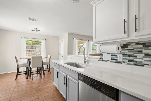 a kitchen with cabinets stainless steel appliances and a counter space