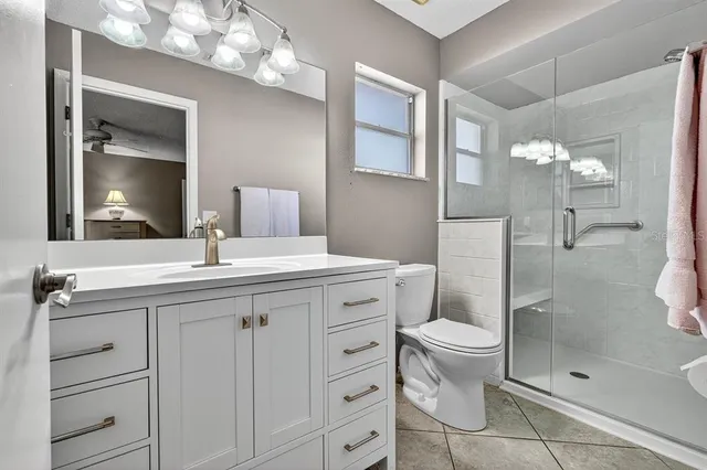 a view of a yard with plants and large trees