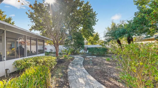 a view of a porch with chairs and potted plants