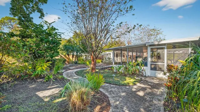 a view of a porch with furniture and garden
