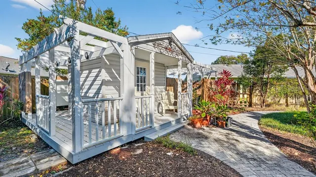 an aerial view of residential houses with outdoor space and trees