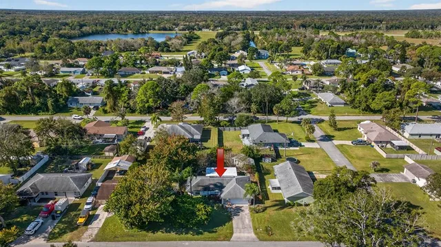 an aerial view of residential house with outdoor space and swimming pool