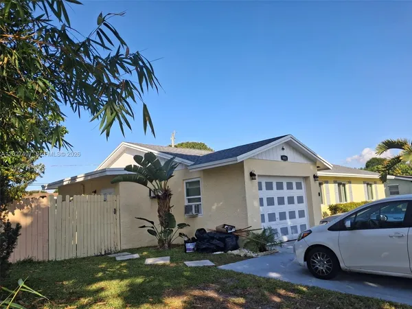 a front view of a house with parking area