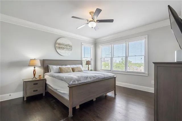 a large bed sitting in a bedroom next to a window