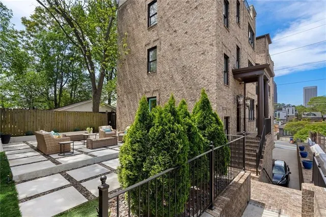 a view of backyard with outdoor seating and plants