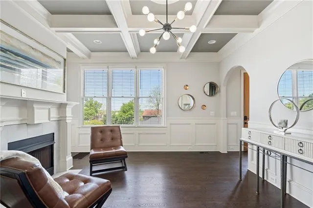 a living room with furniture a fireplace and a large window