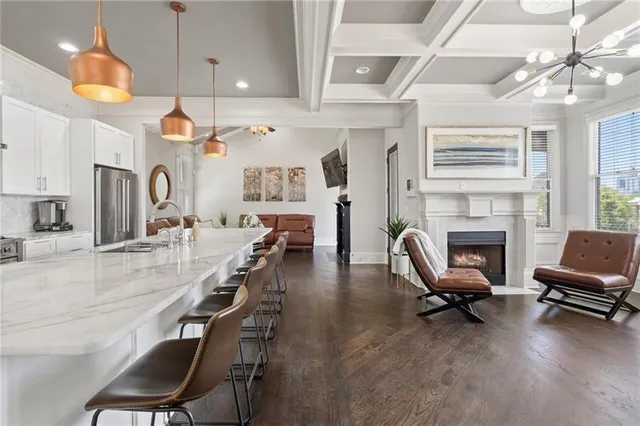 a living room with furniture a fireplace and a chandelier