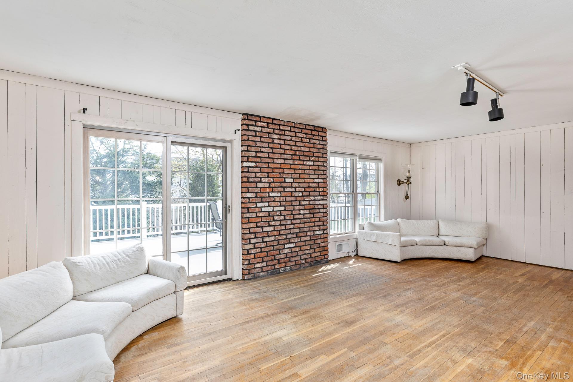 10 Fortune Court Commack, NY 11725 - Photo 14 of 34 LIving room with hardwood flooring and sliders to the deck.