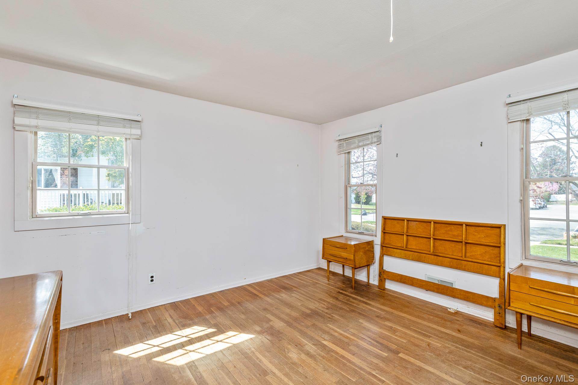 10 Fortune Court Commack, NY 11725 - Photo 19 of 34 Spacious primary bedroom with hardwood flooring.
