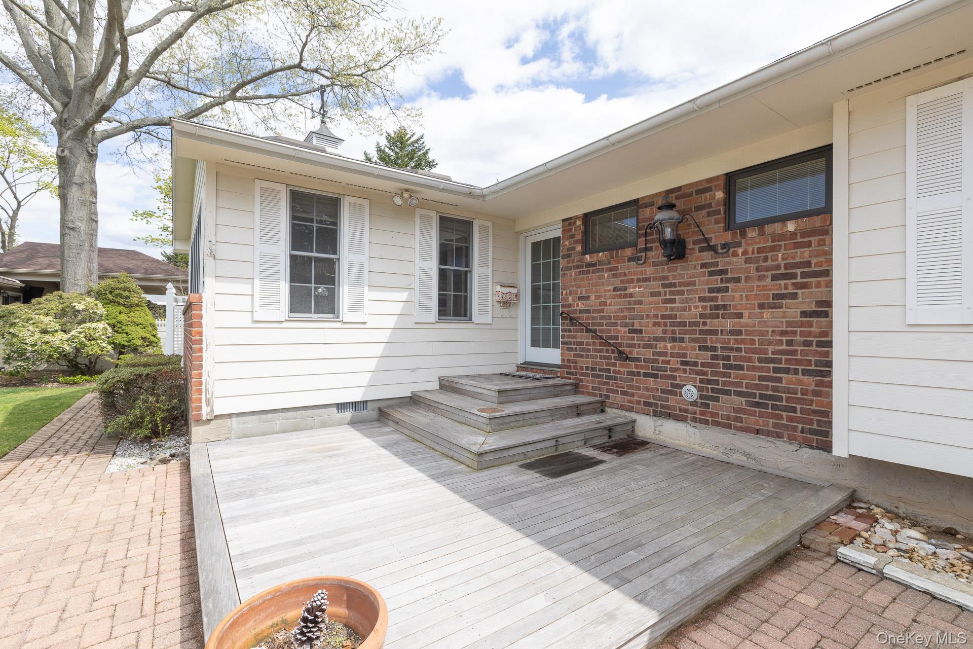 10 Fortune Court Commack, NY 11725 - Photo 5 of 34 Welcoming entry deck perfect for outdoor bench and decor
