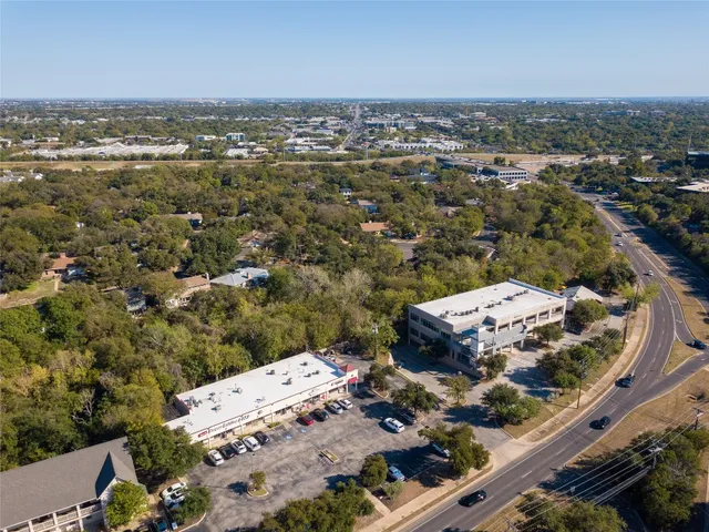 an aerial view of a house with a mountain