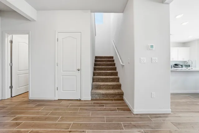 a view of a livingroom with wooden floor and entryway