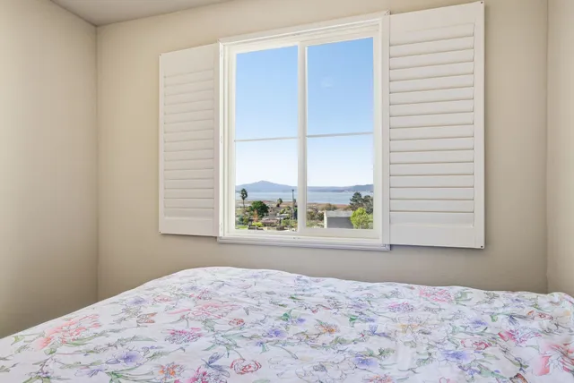 a bedroom with a bed and a window