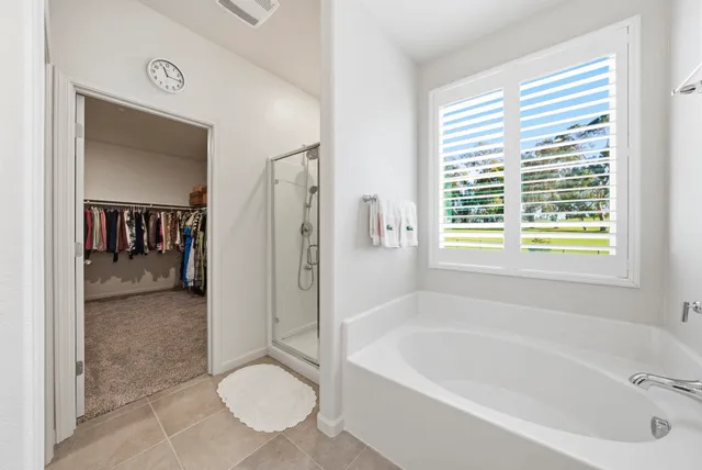 a bathroom with a tub shower and toilet