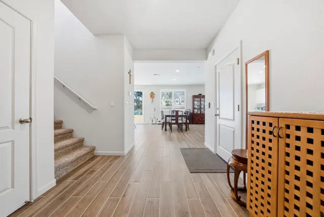 a living room with furniture and a table with wooden floor