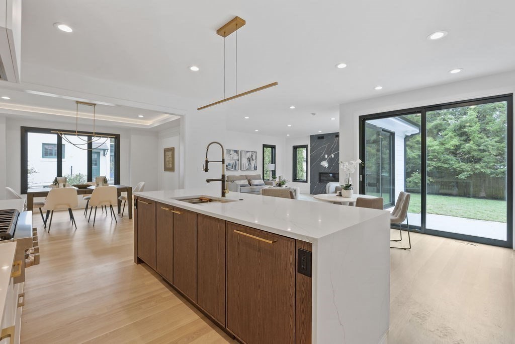 108 Bradford Street Needham, MA 02492 - Photo 11 of 42 a large kitchen with large windows and a table
