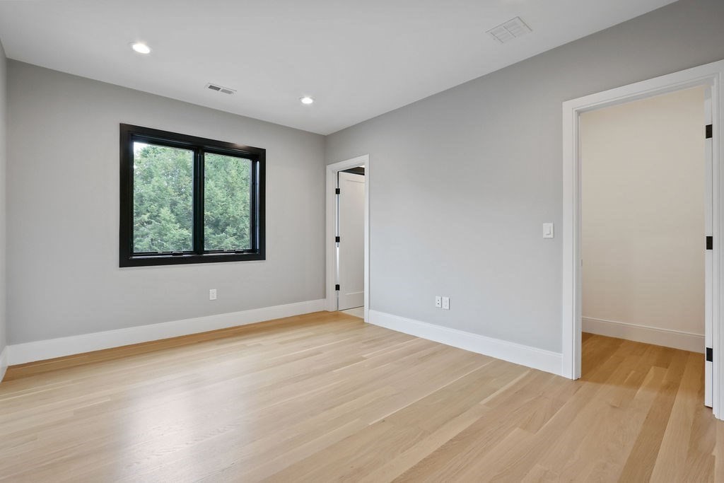108 Bradford Street Needham, MA 02492 - Photo 27 of 42 an empty room with wooden floor and windows