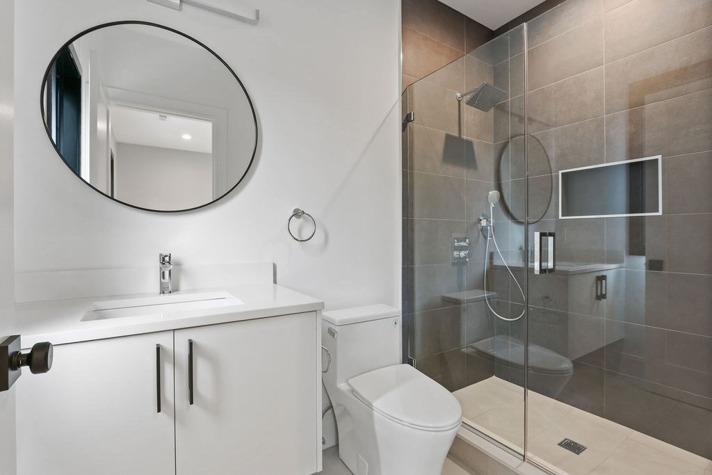 108 Bradford Street Needham, MA 02492 - Photo 28 of 42 a bathroom with a toilet sink vanity and shower