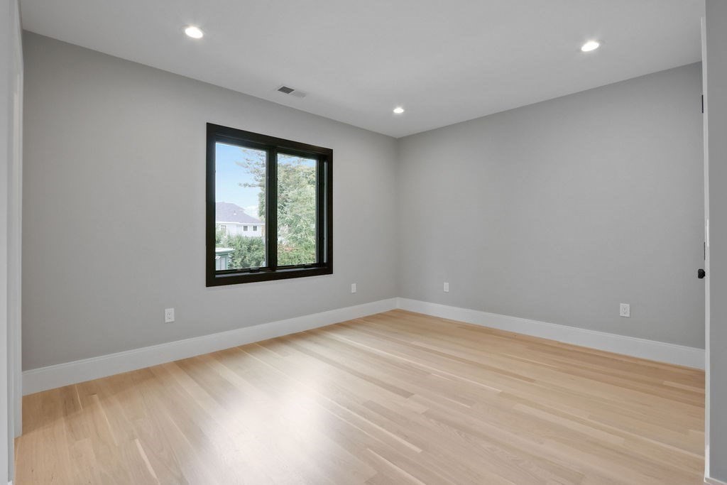 108 Bradford Street Needham, MA 02492 - Photo 32 of 42 an empty room with wooden floor and windows