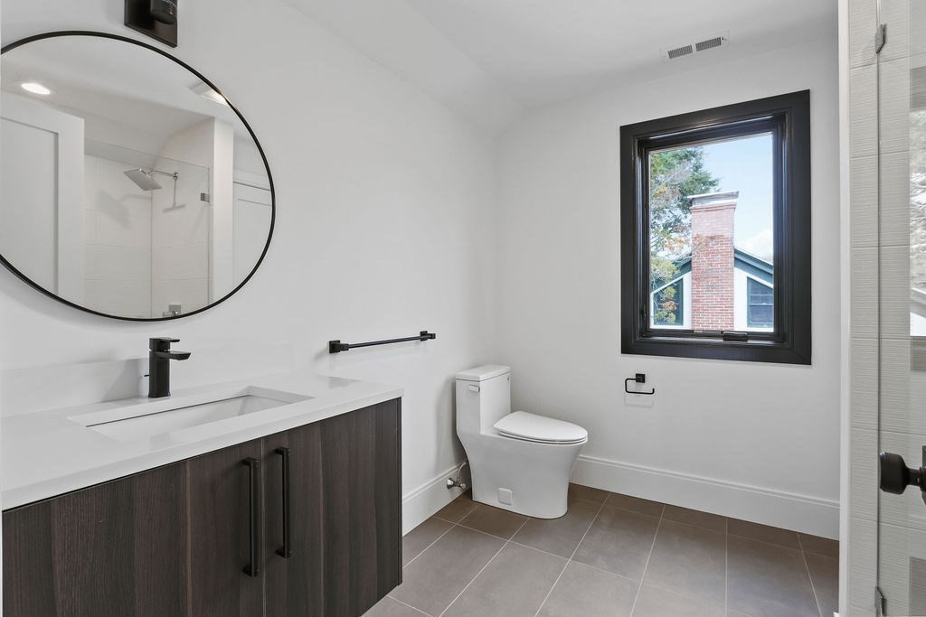 108 Bradford Street Needham, MA 02492 - Photo 33 of 42 a bathroom with a toilet sink and mirror