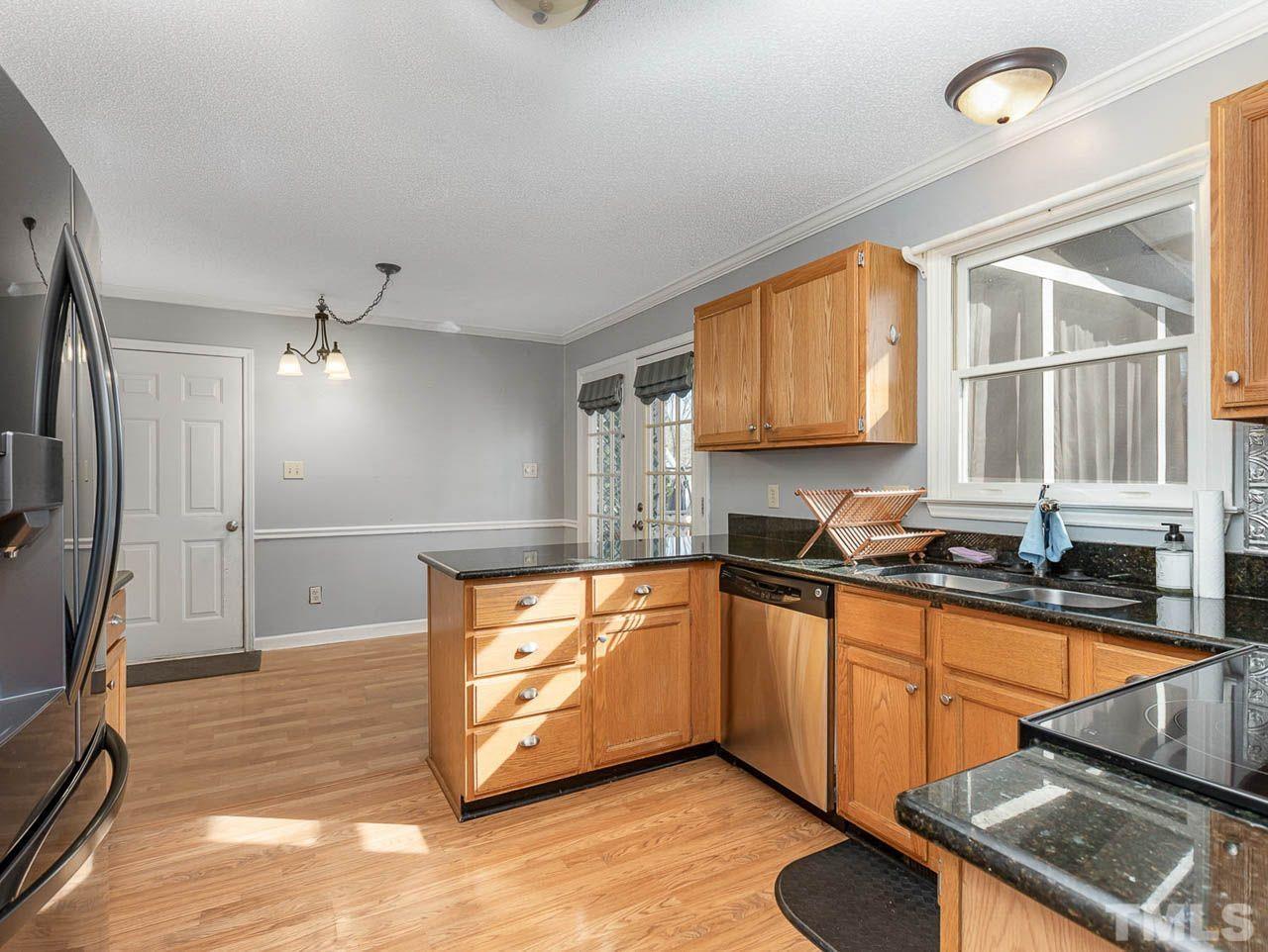 2512 Holbrook Court Raleigh, NC 27604 - Photo 13 of 26 a kitchen with stainless steel appliances granite countertop a sink stove and refrigerator