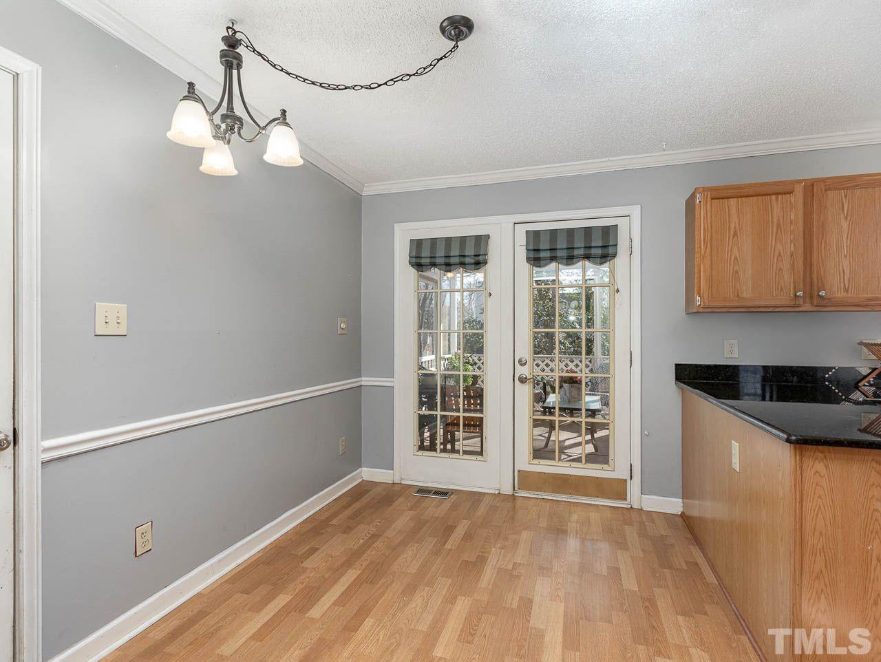 2512 Holbrook Court Raleigh, NC 27604 - Photo 14 of 26 a view of an empty room with wooden floor and a window